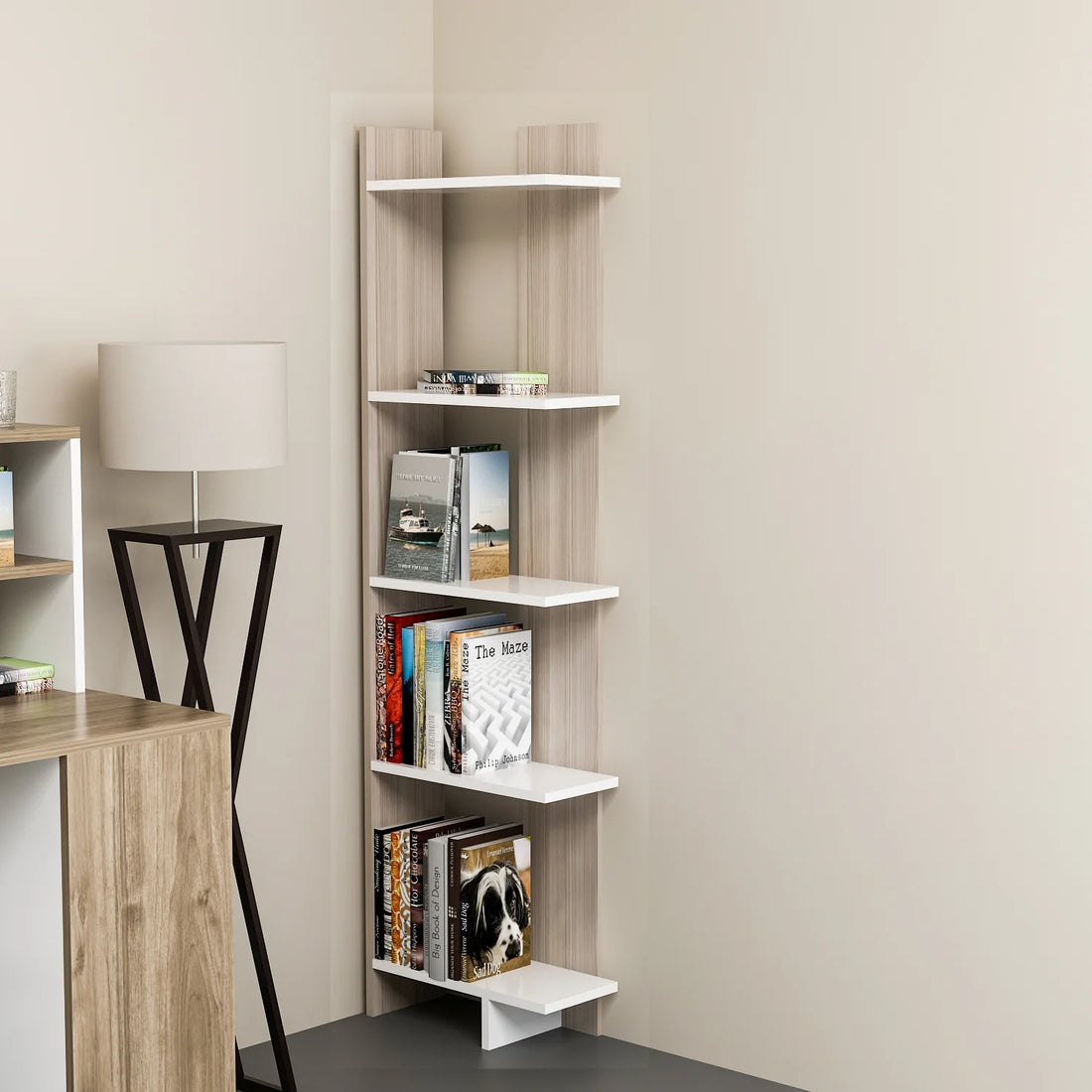 White corner bookcase styled with books plants and decor